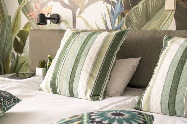 palm tree design hotel rooms with comfortable beds at beachfront hotel rhodes, greece
